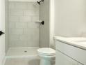 Clean, bright bathroom featuring tiled shower, white toilet, and modern sink, providing a functional and stylish space at 1514 Gatekeeper Ter, Marietta, GA 30066