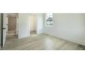 Bright bedroom with light wood floors, white walls, and windows that let in natural light, creating a serene and inviting space at 1514 Gatekeeper Ter, Marietta, GA 30066