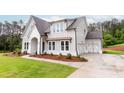 Charming two-story home with landscaped yard and covered entry at 6490 Mockingbird Rd, Cumming, GA 30028