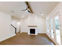 Open-concept living room with vaulted ceilings, fireplace, and French doors to the outdoor space at 6490 Mockingbird Rd, Cumming, GA 30028