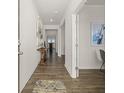 Inviting entryway featuring hardwood floors, neutral walls adorned with artwork, and an open view into the home's interior at 3511 Summerlin Pkwy, Lithia Springs, GA 30122