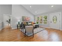 Inviting living room featuring hardwood floors, large windows, and a cozy sofa at 1551 Avon Ave, Atlanta, GA 30311