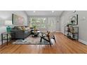 Stylish living room with hardwood floors, gray sofa, and lots of natural light at 1551 Avon Ave, Atlanta, GA 30311