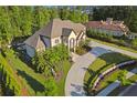 Beautiful two-story home with lush landscaping, curved driveway, and mature trees at 4434 Oglethorpe Nw Loop, Acworth, GA 30101