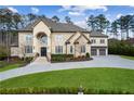 Charming home featuring a well-maintained lawn, a curved driveway, and a welcoming facade at 4434 Oglethorpe Nw Loop, Acworth, GA 30101