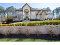 Beautiful stone-faced home with a manicured front yard and retaining wall landscaping at 4434 Oglethorpe Nw Loop, Acworth, GA 30101