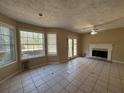 Spacious living room with fireplace, tile floors, and sliding doors to the backyard at 904 Crossing Rock Dr, Lawrenceville, GA 30043