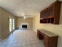 Bright living room featuring a fireplace, built in cabinet, and tile floors at 904 Crossing Rock Dr, Lawrenceville, GA 30043