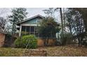 Exterior view of home with steps leading up to the screened porch at 1687 Neely Ave, Atlanta, GA 30344