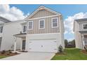 Charming two-story home featuring neutral siding, well-manicured lawn, and a two car garage at 2019 Wyndham Pl, Conyers, GA 30013