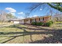 Well-maintained single-story home with brick accents, a lovely yard, and a concrete driveway at 3606 Trickum Ne Rd, Marietta, GA 30066