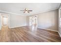 Spacious living room with fresh paint, modern ceiling fan and attractive light-colored flooring at 3606 Trickum Ne Rd, Marietta, GA 30066