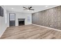 Hardwood floors in a living room with fireplace and patterned wallpaper at 3242 Kingswood Gln, Decatur, GA 30034