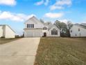 Charming two-story home featuring a two-car garage and landscaped front yard at 4200 Flakes Mill Manor Ln, Ellenwood, GA 30294