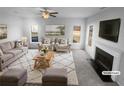 Bright living room features a fireplace, plush seating, and ample natural light at 4200 Flakes Mill Manor Ln, Ellenwood, GA 30294