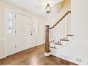 Bright foyer featuring hardwood floors, a staircase, and a paneled front door at 5275 Redfield Ct, Atlanta, GA 30338