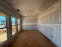 Unfinished room featuring multiple windows that let in natural light and walls ready for paint at , Conyers, GA 30094