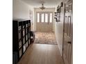 Welcoming foyer with stylish rug and shelving adjacent to hardwood flooring at 180 Collins Way, Locust Grove, GA 30248