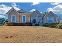 Charming single-story home with brick facade and manicured lawn and mature landscaping at 101 Fair Oaks Cir, Stockbridge, GA 30281
