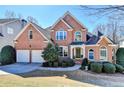 Beautiful two-story brick house with a landscaped yard and a welcoming entrance at 1301 Dayspring Trce, Lawrenceville, GA 30045
