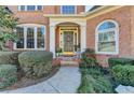 Close-up of the front entrance showing a walkway and neatly trimmed hedges at 1301 Dayspring Trce, Lawrenceville, GA 30045