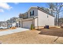 Two-story home with classic brick and siding, a two-car garage, driveway and manicured lawn at 1761 Dosk Ave, Lawrenceville, GA 30044