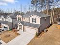 A two-story home showcases a classic design with brick detailing, siding, an attached garage, and a driveway at 1761 Dosk Ave, Lawrenceville, GA 30044