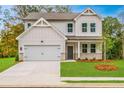 Charming two-story home with a well-manicured lawn and attached two-car garage at 142 Henley St, Canton, GA 30114