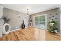 Modern dining area boasts hardwood floors, sliding glass door to the deck, and contemporary lighting at 3087 Sanibel Sw Dr, Stone Mountain, GA 30087