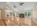 Spacious living room featuring hardwood floors, fireplace, and ceiling fans at 3087 Sanibel Sw Dr, Stone Mountain, GA 30087