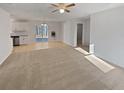 An empty living room with new carpet and attached kitchen and dining area at 3103 Mote Rd, Covington, GA 30016
