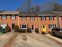 Brick townhomes featuring driveways and lush landscaping, creating a welcoming neighborhood setting at 1098 Westfield Se Trce, Smyrna, GA 30082