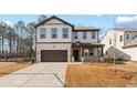 Charming two-story home with brick and siding, a two-car garage and a well-maintained lawn at 148 Henley St, Canton, GA 30114