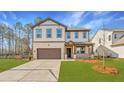 Charming two-story home with a well-manicured lawn and a two car garage at 148 Henley St, Canton, GA 30114