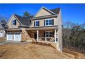 Beautiful two-story house with a stone facade, two-car garage, and a cozy front porch at 30 Grand Georgian Ne Ct, Cartersville, GA 30121