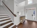 Bright foyer featuring hardwood floors, a staircase, and a view of the front door at 4869 Locherby Dr, Fairburn, GA 30213