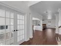 Elegant living room with hardwood floors, white trim, and French doors leading to the office at 4869 Locherby Dr, Fairburn, GA 30213