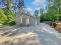 Lovely home featuring a new driveway and a charming covered front porch with stone and wood columns at 1950 S Inlet, Marietta, GA 30066