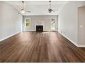 Spacious living room with vaulted ceilings, fireplace, wood floors, and natural light, perfect for entertaining guests at 1950 S Inlet, Marietta, GA 30066