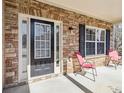 Inviting front porch with stone accents, features a stylish front door, sidelight, and two chairs at 3158 Arbor Oaks Way, Snellville, GA 30039