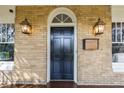Elegant front door with sidelights, vintage-style lanterns, and mailbox, creating a welcoming entrance at 750 Clemont Ne Dr, Atlanta, GA 30306