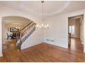 Formal dining room with hardwood floors, decorative molding, chandelier, and access to the staircase at 1755 Presidents Dr, Lawrenceville, GA 30043