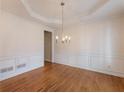 Formal dining room with hardwood floors, decorative molding, and a stylish chandelier at 1755 Presidents Dr, Lawrenceville, GA 30043