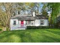Charming single story home with a red front door and inviting curb appeal at 2132 Penrose Dr, East Point, GA 30344
