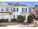 Charming two-story townhome with gray siding and black shutters, complemented by manicured landscaping and a well-maintained lawn at 3525 Parc Sw Cir, Atlanta, GA 30311