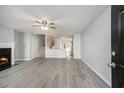 Spacious living room with a cozy fireplace, light gray walls, and modern gray laminate flooring throughout the house at 3525 Parc Sw Cir, Atlanta, GA 30311