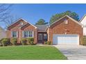 All brick, one-story home with green grass and well maintained landscaping at 720 Nightwind Way, Stockbridge, GA 30281