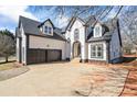 Charming home exterior featuring a two-car garage, elegant entrance, and well-maintained landscaping at 3955 Pucketts Rd, Snellville, GA 30039