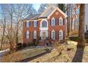 Beautiful red brick home with black shutters, a front yard and a long driveway at 450 Congress Pkwy, Lawrenceville, GA 30044