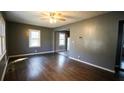 Open-concept living room featuring hardwood floors and large windows for ample sunlight at 4681 City View Dr, Forest Park, GA 30297